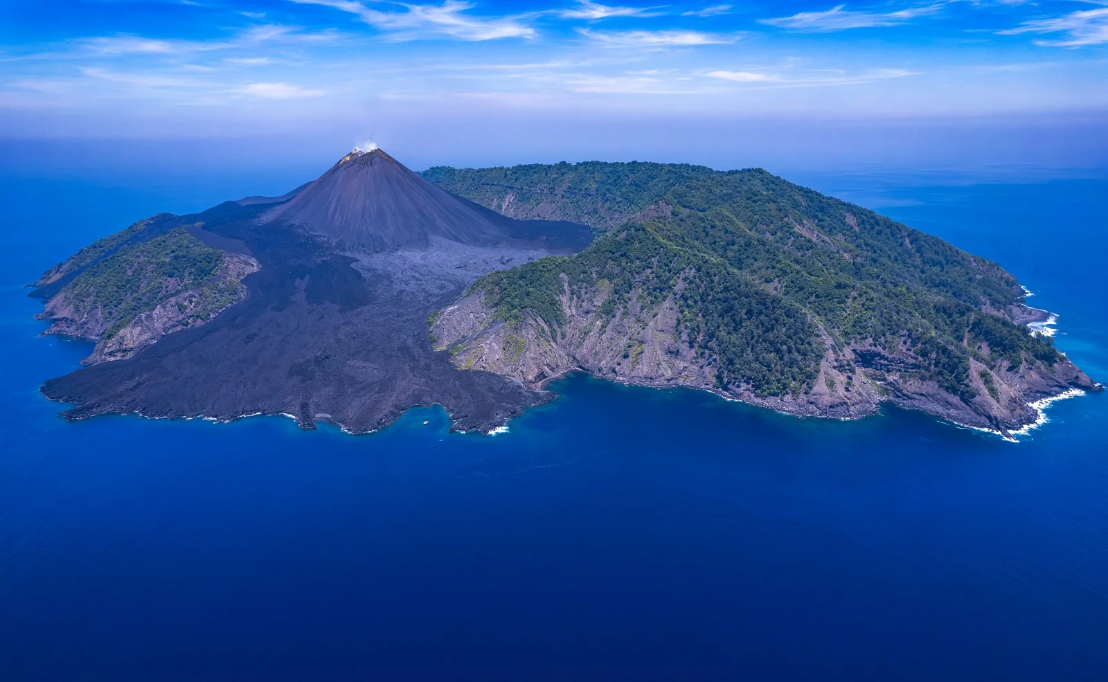 Barren Island volcanic cone and rocky coastline viewed from above, supplied by Andamanica